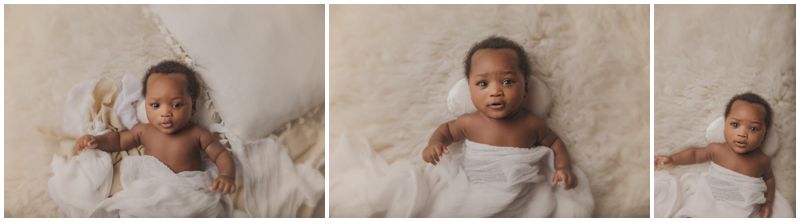 A baby lies comfortably wrapped in soft white linens, gazing with gentle curiosity. Captured by a Canberra baby photographer, this image exudes warmth and innocence in a serene setting